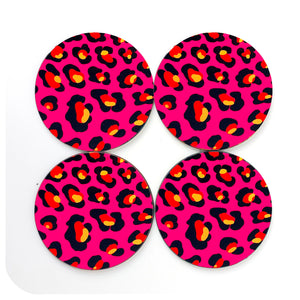 A set of 4 round leopard print coasters in hot pink, with orange and yellow spots on a white background | The Inkabilly Emporium