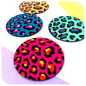 Four colourful Leopard Print Coasters lie scattered on a white background | The Inkabilly Emporium