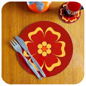 A single round 70s floral placemat on teak table with coaster and cutlery, fat lava vase & vintage espresso mug | The Inkabilly Emporium