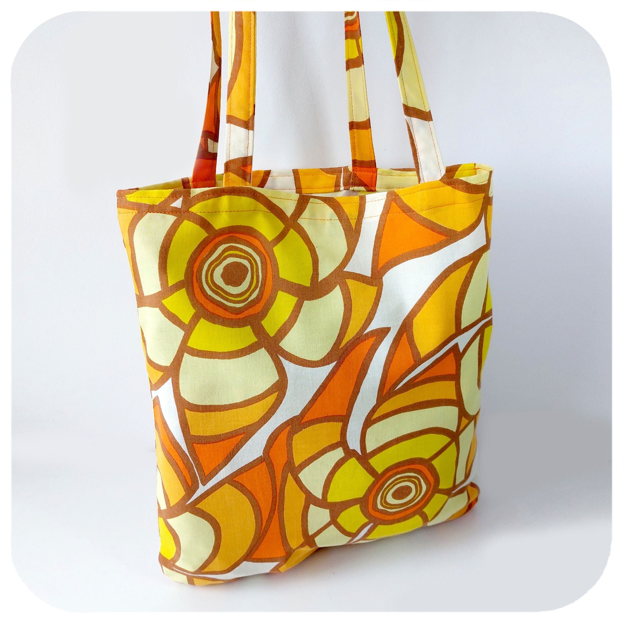 Tote bag made from vintage fabric featuring yellow & orange flowers | The Inkabilly Emporium