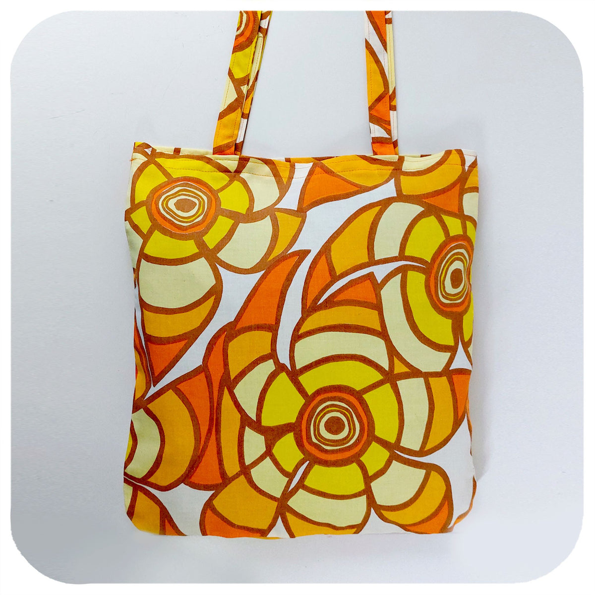 Tote bag made from vintage fabric featuring yellow & orange flowers | The Inkabilly Emporium